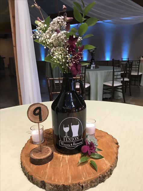 Growlers used for a table centerpiece . Brewery wedding, rustic, outdoor theme in Fenton Michigan. #michiganweddings #weddingvenue Growler Centerpiece, Beer Centerpieces, Fenton Michigan, Beer Themed Wedding, Inexpensive Wedding Centerpieces, Beer Wedding, Bottle Centerpieces, Brewery Wedding, Diy Rustic Decor