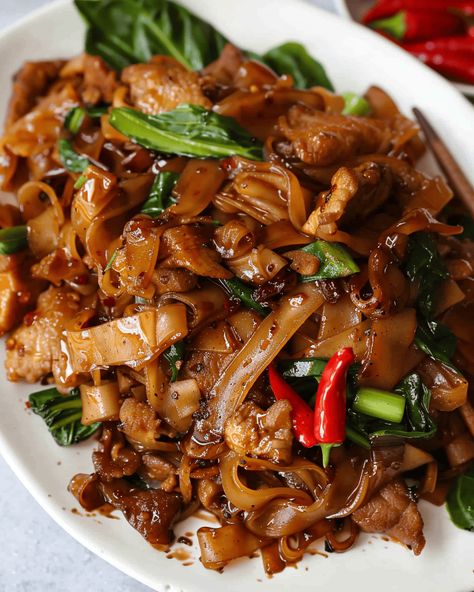 Thai Drunken Noodles (Pad Kee Mao): A Spicy, Flavor-Packed Stir Fry If you’re a fan of bold flavors and spicy dishes, this Thai Drunken Noodles (Pad Kee Mao) recipe is ... Read more Dinner Recipes Chinese, Pad Kee Mao Recipe, Beef Chow Fun Recipe, Beef Chow Fun, Chow Fun Recipe, Cantonese Recipes, Thai Drunken Noodles, Fried Rice Noodles, Asian Noodle Dishes