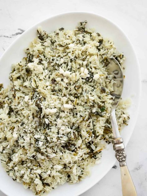 This veggie filled Spinach Rice makes a great bed for grilled meats or vegetables, and adds an extra pop of flavor thanks to feta cheese. BudgetBytes.com Feta Rice, Food Grains, Greek Rice, Yogurt Marinated Chicken, How To Make Spinach, Mediterranean Foods, Spinach Rice, Tomato Dishes, Dinner Snacks