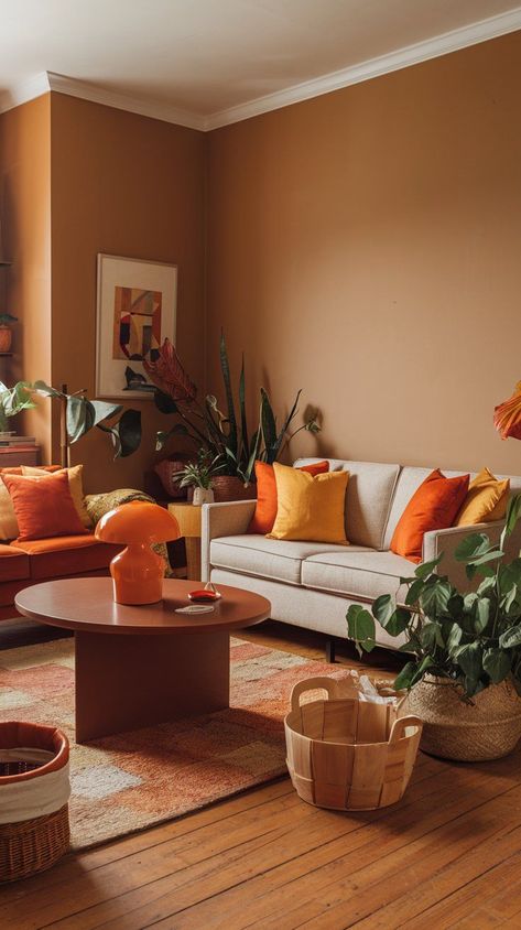 Use our guide to decorating with fall color schemes to enhance every room. From the living room to the bedroom, introduce autumn’s warmth throughout your home. Fall Color Interior Design, Cosy Room Colours, Pale Orange Living Room, Apartment Esthetics, Dopamine Apartment, Autumn Home Aesthetic, Warm Colors For Living Room, Cozy Fall Room Decor, Warm Living Room Colors