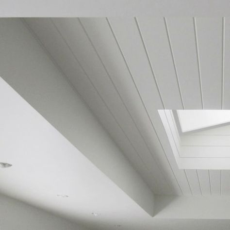 V-groove WOTG covers this ceiling and skylight detail. Credit: TS Inc. in CA V Groove Paneling Ceiling, V Groove Ceiling, Vaulted Ceiling Skylight, Skylight Detail, Kitchen Skylight, White Beach House, Deck Addition, Architecture Ceiling, Taupe Kitchen