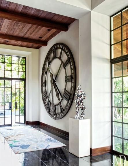 The bar area at a Hollywood producer's estate showcases a vintage clock from Blackman Cruz and a sculpture by Jean Dubuffet. Large Contemporary Wall Clock, Movie Producer, Big Wall Clocks, Mediterranean Revival, Modern Living Room Wall, Wall Clocks Living Room, Contemporary Wall Clock, Oversized Wall Clock, Foyer Decorating