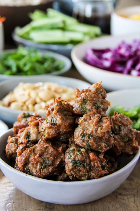 a close up of a bowl of Vietnamese chicken meatballs Summer Roll Salad, Easy Cream Puffs, Cream Puffs Easy, Chicken Meatball Soup, Summer Rolls Recipe, Summer Roll, Vietnamese Chicken, Serve Over Rice, Salad Dinner