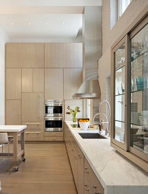 lots of storage along that wall. waterfall countertop. glass cupboard looks a bit strange hovering over the counter though. Loft Inspiration, Tribeca Loft, Kitchen New York, Loft Kitchen, Loft Interiors, Classic Kitchen, White Marble Countertops, Contemporary Kitchen Design, Italian Kitchen