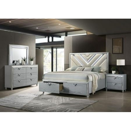 Modern glam energy infuses a four-piece contemporary bedroom set to create a rich, refined centerpiece in your bedroom. The set centers of a stylish storage bed, featuring LED lighting in an upholstered headboard with snow white fabric. Its chevron detail adds a sense of movement to the bed and is echoed in V-shaped, jeweled handles that decorate each drawer front. There are two drawers for easy storage in the foot of the bed, with a two-drawer nightstand and six-drawer dresser that offer felt-lined top drawers and plenty of space for organizing clothing, accessories, and personal effects. A light silver wood grain finish is bright and refined, while shiny silver trim adds dimension and the included dresser mirror offers additional LED lighting to set the ambiance for relaxed lounging. Modern Bedroom Storage, Led Headboard, Contemporary Bedroom Sets, Murphy Cabinet Bed, Wood Bedroom Sets, Colorful Headboard, Eastern King Bed, King Storage Bed, Headboard With Lights