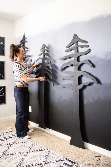 Learn how to easily create your own DIY Forest Accent Wall that will make a huge impact in your space! Cut these trees out of plywood using a jigsaw and give them a coat of paint! Full tutorial on the blog. Wood Trim Accent Wall Mountains, Forest Accent Wall, Tree Accent Wall, Diy Forest Mural, Diy Mountain Wall, Diy Forest, Modern Boys Rooms, Adventure Room, Camp Decor