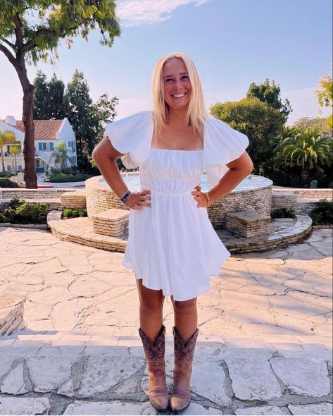 Preppy Cowboy Boots Outfits, Cowgirl White Dress Outfit, White Romper With Cowboy Boots, White Dress And Boots Country, Country White Dress With Boots, Cowboy Boots With White Dress, Dress And Brown Cowboy Boots Outfit, White Sundress Cowboy Boots, White Dress Western Outfit