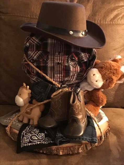 Little Wrangler cowboy diaper cake. Wranglers, cowboy hat, boots, shirt horse tether and puppet wrapped in rope on a wood slab...rustic baby shower. Cowboy Baby Shower Gift Ideas, Cowboy Diaper Cakes For Baby Boy, Rustic Cowboy Baby Shower Ideas, Baby Boy Western Shower Ideas, Western Baby Shower Cake For Boys, Wild West Baby Shower Ideas, A Little Cowboy Is On His Way Decorations, Baby Boy Cowboy Shower Ideas, Cowboy Baby Shower Favors