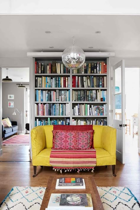 Home Accessory Ideas: It's time to rethink disco balls (houseandgarden.co.uk) Bookshelf Ideas Living Room, Laura Stoddart, Yellow Sofas, Chapel Conversion, Bookshelf Ideas, Living Colors, Bibliotheque Design, Yellow Sofa, Farmhouse Side Table