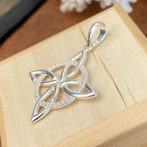 Sterling silver Irish/Scottish celtic trinity knot charm pendant. The Trinity Knot has a beautiful form with three interlinked leaf-like shapes which give an overall triangular profile. From these relatively simple shapes a seemingly complex trefoil knot is formed, a knot which cannot be untied. Although there are many interpretations of the trinity knot, ancient Christianity believes the three points represent the three elements of the holy trinity: Father, Son, + Holy Spirit. Measures: 1 1/8" Celtic Wedding Band Set, Eternity Knot, Celtic Crosses, Scottish Celtic, Bead Embroidered Bracelet, Celtic Wedding Bands, Embroidered Bracelet, Saint Jewelry, Heaven Quotes