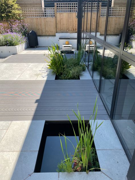 Contemporary fish pond with compositw decking bridges and waterfall. Pond Bridge, Contemporary Patio, Bridge Design, Fish Pond, Patio Design, Water Features, Home Projects, Front Door, Garden Design