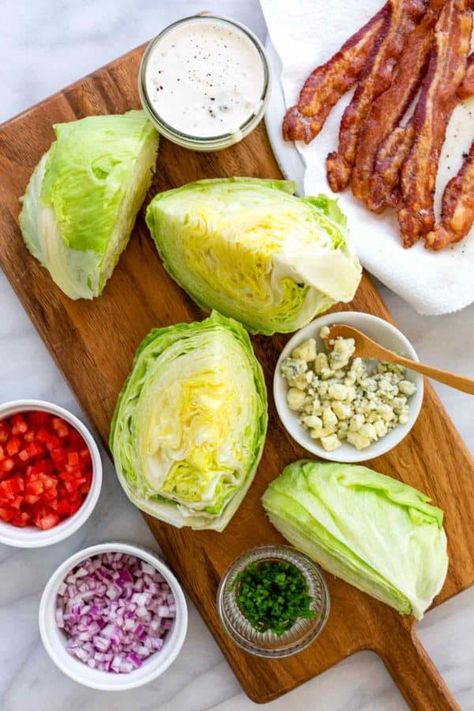 Classic wedge salad recipe using iceberg lettuce topped with a tangy blue cheese dressing, smokey bacon, diced red onion, tomato, and chives. #wedgesalad #bluecheese #salad Salad Recipes Iceberg Lettuce, Blue Cheese Wedge Salad, Iceberg Lettuce Recipes, Blue Cheese Wedge Salad Recipes, Ice Berg Lettuce Salad, Iceberg Wedge Salad Blue Cheese, Grilled Buffalo Chicken Sandwich, Chicken Carbonara Pasta, Iceberg Wedge Salad