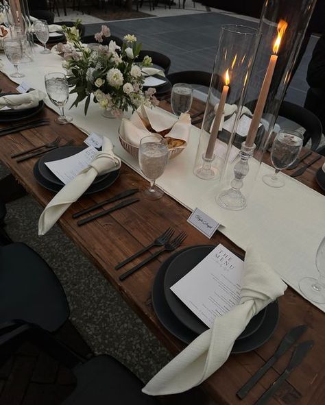 Mumu Weddings shared a post on Instagram: "the tablescapes were definitely some of my favorite details from the wedding—the black table settings and dark wood contrasted with the lush greenery of south carolina was so elegant and timeless. it truly was a stunning black tie affair!". Follow their account to see 4549 posts. Black Place Mat Table Setting, Dark Brown Dining Table Round, Dark Wood Table Setting Ideas, Black And Wood Dinner Table, Table Runner On Dark Wood Table, Masculine Dinner Table Decor, Black And Wood Party Decor, Black And Wood Table Setting, Wood And Silver Decor