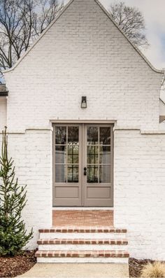 White Brick House With Brown Roof, Cream Exterior Brick, Cap Cod Exterior Paint Colors, White Brick Entryway Exterior, Creamy Brick Exterior, White And Taupe House Exterior, White House Taupe Door, House Interior Wall Paints, Cromwell Gray Exterior