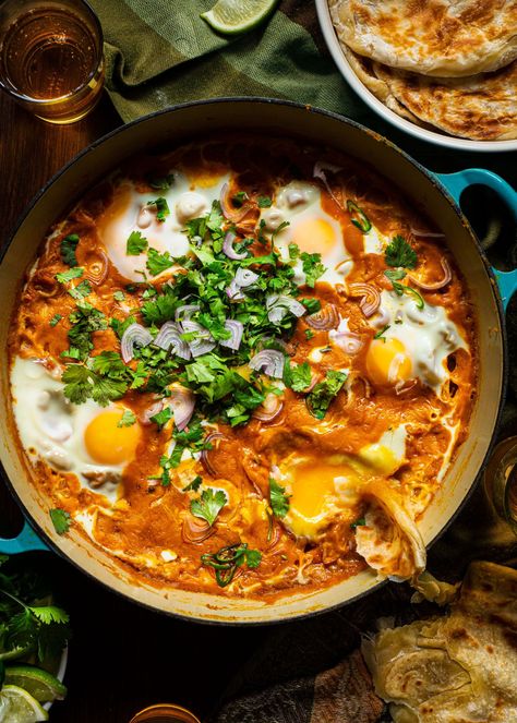 These Chickpea Curried Eggs feature delicately poached eggs simmered in a golden chickpea curry served alongside a stack of crisp and flaky paratha. #chickpeacurry #coconutcurry #paratha #curriedeggs Flaky Paratha, Curried Eggs, Middle East Recipes, Egg Curry, Paratha Recipes, Chickpea Curry, Coconut Curry, Delicious Dinner Recipes, Breakfast Brunch Recipes