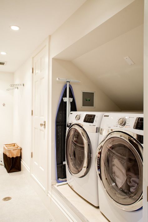 Lovely laundry room features front-load washer and dryer in small nook. Sun Tunnel Skylight, Laundry Decor Ideas, Ironing Room, Room In Attic, Small Washer And Dryer, Laundry Wardrobe, Compact Laundry Room, Sun Tunnel, Contemporary Laundry Room