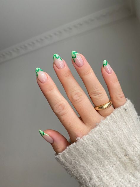 French Chic with a Fresh Touch! 🌿✨ Elevate the classic French manicure with vibrant green tips and a subtle swirl in a lighter green hue. This modern twist breathes new life into timeless elegance, perfect for spring! 💅🏼  
#GreenSpringNailsAlmond #NailInspo2025 #VacationNailsGreen #GreenFreestyleNails Green Swirls Nails, Green Spring Nails Almond, Vacation Nails Green, Mail Inspo 2024 Spring, Nails May 2024, Green Summer Nails Designs, Nails Summer Green, Green And Orange Nails, Green Nails Spring