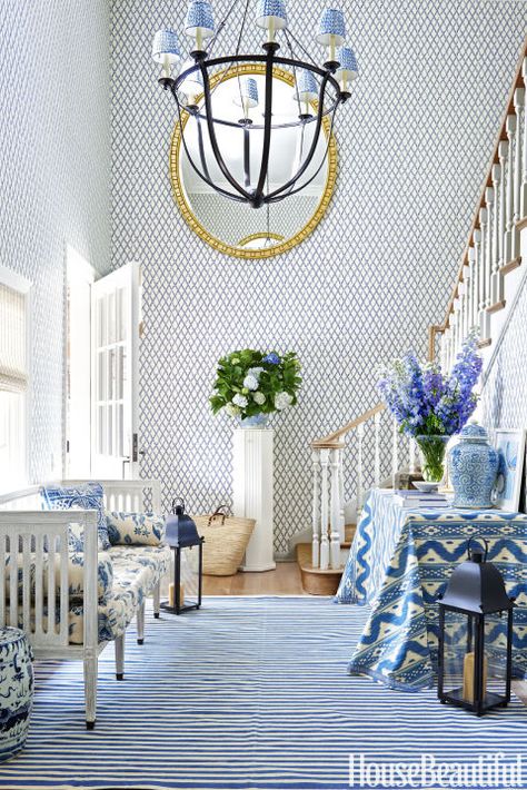 Mark D. Sikes - House Beautiful This two story entryway by Mark D. Sikes is a dream come true for the lover of blue and white Chinoiserie. The wallpaper is China Seas, the blue and white striped rug i Wallpaper Bali, White Foyer, Mark Sikes, Bamboo Wallpaper, Blue And White Living Room, Beverly Hills Houses, Blue White Decor, Foyer Decorating, Foyer Design