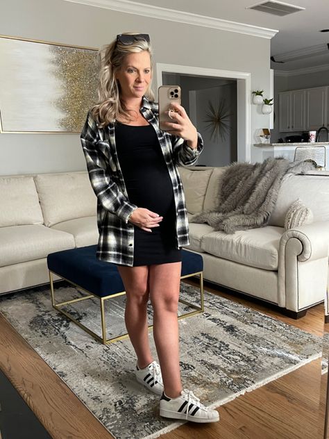 Simple black maternity dress with flannel and superstars Black Maternity Dress Outfit, Black Dress And Flannel Outfit, Black Dress With Flannel, Dress And Flannel Outfit, Maternity Black Dress Outfit Casual, Dress With Flannel, Maternity Dress With Flannel, Dress With Tshirt, Black Sweater Dress Outfit