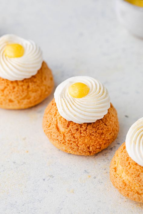 These Paris style lemon cream puffs will have everyone wanting more! These lemon puffs are made with craquelin, pate a choux, lemon curd, and stabilized whipped cream. You can make them with or without the extra whipped cream and curd on top. Either way, these are impressive cream puffs! I often take my inspiration from Paris patisseries where you can buy choux pastries, craquelin, and cream puffs. Lemon Cream Puffs, Cream Puff Dough, Choux Cream, Cream Puff Recipe, Stabilized Whipped Cream, Choux Pastry, Paris Style, Lemon Cream, Lemon Meringue