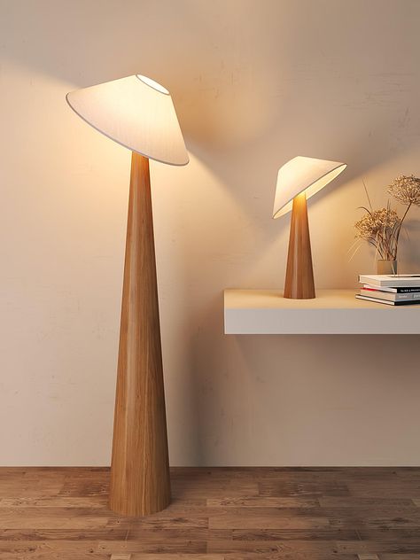 This lamp features a solid wooden base that ascends in a sleek, conical form, emphasizing the wood's natural beauty and texture. At its zenith, a gently tilted metal arm cradles a triangular fabric shade, reminiscent of a canopy leaf floating gracefully in the forest. The soft light that filters through the fabric shade provides a warm, ambient glow, perfect for creating a cozy atmosphere in any room. The fusion of metal's modern edge with the organic feel of wood and the softness of the fabric makes the Tilt Hat Wooden Table Lamp a versatile addition to a variety of decor styles, from Scandi-chic to mid-century modern, and a striking piece that draws the eye with its elegant poise and innovative design. 
 Product color and lighting real shot display: 
 
 If you have any questions about ou Scandi Chic, Wooden Floor Lamps, Diy Light, Metal Arm, Wooden Table Lamps, Task Floor Lamp, Chandelier Floor Lamp, Led Desk Lamp, Ceiling Chandelier