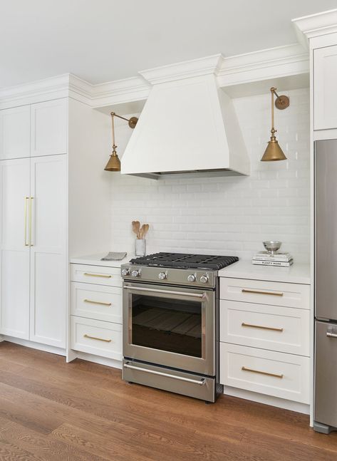 Hood With Sconces, Kitchen Floating Shelves Wood, Wood Range Hoods, Kitchen Sconces, White Beveled Subway Tile, Floating Shelves Wood, Gorgeous White Kitchen, Grey Floating Shelves, Herringbone Tile Backsplash