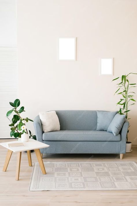 Premium Photo | A dusty blue sofa with pillows a white coffee table potted plants in a bright cozy living room Dusty Blue Sofa, Bright Cozy Living Room, Sofa With Pillows, White Coffee Table, Blue Sofa, Coffee Table White, White Pillows, White Coffee, Cozy Living Rooms