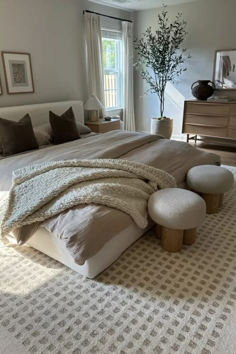 Why not start the fall season with a fall bedroom refresh? These neutral organic bedroom decor ideas will give you a cozy bedroom with a fall aesthetic. Shop these neutral bedding finds, ottomans and neutral rug ideas here to decorate your cozy winter bedroom.

#bedroomrefresh #fallaesthetic #bedroomdecor #cozybedroom Neutral Rooms Bedroom, Cream Tan Bedding, Earthy Beige Bedroom, Dark Floor Master Bed, White Bedroom With Wood Furniture, Home Bedroom Aesthetic, Beige Bedspread Ideas, Cozy Bedroom King Bed, Bed Under A Window Ideas