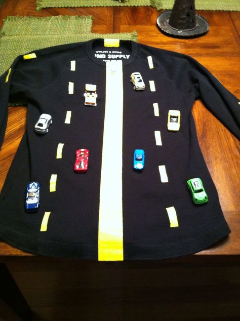 Road costume. Use yellow duck tape for the road lines. Sew cars onto a heavier fabric shirt, I used a thermal shirt. When I sewed the cars I wrapped the thread around the wheels between stitches. Fork In The Road Costume, Road Costume, Car Costume, Road Lines, Monkey Puzzle, Halloween Board, Fork In The Road, 1 September, Duck Tape