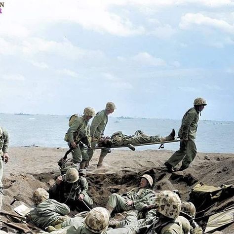 the_ww2_memoirs US Navy Corpsmen carry a wounded Marine on a stretcher to await the evacuation off the island of Iwo Jima while a group of Marines huddle in a shell hole that is providing some cover to them. 72 years ago today over 30,000 Marines stormed the shores of this tiny volcanic island making their mark on history forever. Years before the landings the Japanese commander in the island had predicted the Americans would attempt to land here and he began to build up his defenses. He did thi Hospital Corpsman, Battle Of Iwo Jima, Perang Dunia Ii, Navy Corpsman, D Day Invasion, Iwo Jima, Leyte, Us Marines, Us Marine Corps