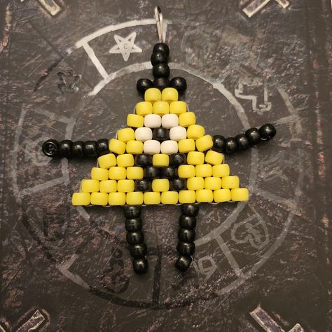 Keychains made to look like Bill Cipher from Gravity Falls Bill Cipher Kandi Pattern, Things To Make Out Of Metal, Pop Tab Keychain, Gravity Falls Bracelet Ideas, Weird Stuff To Buy, Bill Cipher Perler Beads, Gravity Falls Bracelet, Ladder Stitch Kandi, Gravity Falls Dipper X Bill