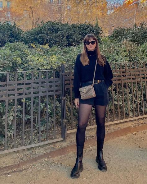 Woman wearing a black sweater, black shorts, black tights, black boots, and a beige YSL bag. Ysl Toy Loulou Bag Outfit, Ysl Loulou Bag Outfit, Ysl Toy Loulou, Ysl Bag Outfit, Ysl Loulou Bag, Ysl Outfit, Taupe Outfit, Nude Bags, Bag Outfit