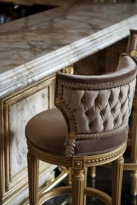 Luxurious bar stool with tufted upholstery and ornate detailing next to a marble countertop. Fancy Bar, Luxury Bar Stools, Kitchen Aesthetics, Island Stools, Perfect Bar, Modern Counter Stools, Seating Ideas, Stools For Kitchen Island, Wooden Bar Stools