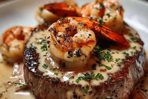 Indulge in tender filet mignon topped with shrimp and lobster cream sauce. This easy surf and turf recipe is perfect for special occasions. Filet Mignon With Shrimp Recipes, Best Surf And Turf Recipes, Surf And Turf Recipes Shrimp, Filet Oscar Recipe, Easy Surf And Turf Recipes, Surf And Turf Recipes, Filet Oscar, Surf N Turf Recipes, Lobster Cream Sauce