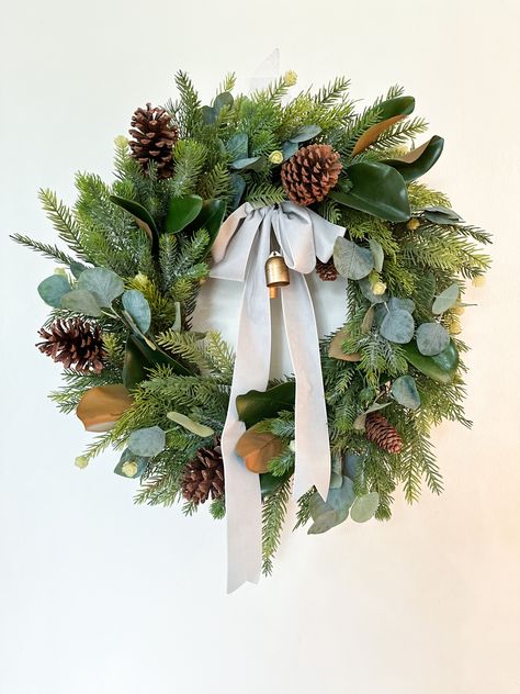 Artificial winter wreath with Real Touch Magnolia, eucalyptus, and pine with gold bells and gray velvet ribbon. Magnolia And Eucalyptus Christmas Wreath, Magnolia And Evergreen Garland, Christmas Wreath With Lambs Ear, Magnolia Eucalyptus Wreath, Winter Wreath With Lambs Ear, Eucalyptus And Pine, Christmas Greenery Wreath, Summer Porch Decor, Window Wreath