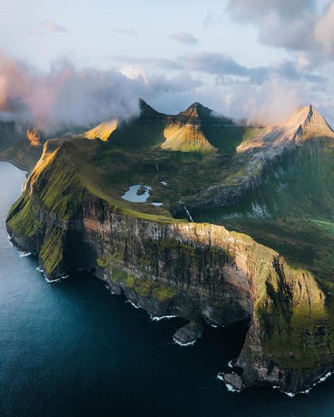 Luke Stackpoole on Instagram: “The magical Faroesian coastline glowing in the last sun rays of the day, those clouds cleared right at the last minute! ⛰ . . . . .…” Country List, Mountains And Water, Faroe Island, Landscape With Mountains, Image Reference, Green Country, Countries In The World, Photography Guide, Green Landscape