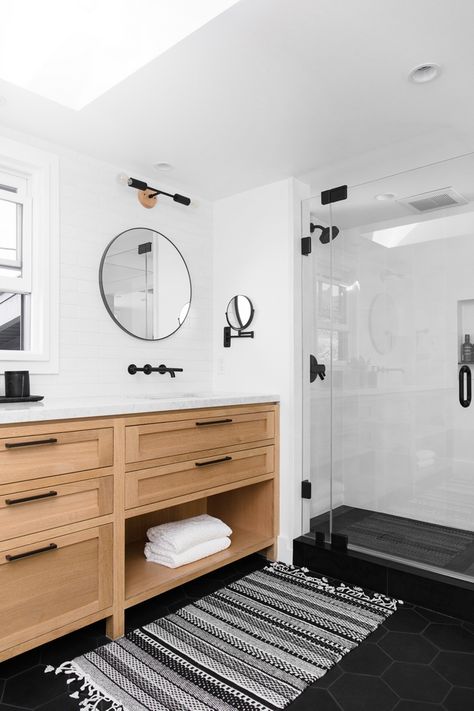 Bathroom Rift Oak Vanity with white marble top black matte hardware Black Round Mirrors Accentuated by Black Modern Sconces and Large Subway Tile on Walls Floor Tile is Large Black Hex Tile Bathroom #Bathroom #BathroomDesign #RiftOak #RiftoakVanity #whitemarble #blackmattehardware #BlackRoundMirrors #BlackModernSconces #LargeSubwayTile #FloorTile #LargeHexTile #BlackHexTile Black Hex Tile Bathroom, White Subway Tile Bathroom, Black Tile Bathrooms, Subway Tiles Bathroom, Bathroom Redesign, Boys Bathroom, Upstairs Bathrooms, Bathroom Remodel Master, Bath Remodel