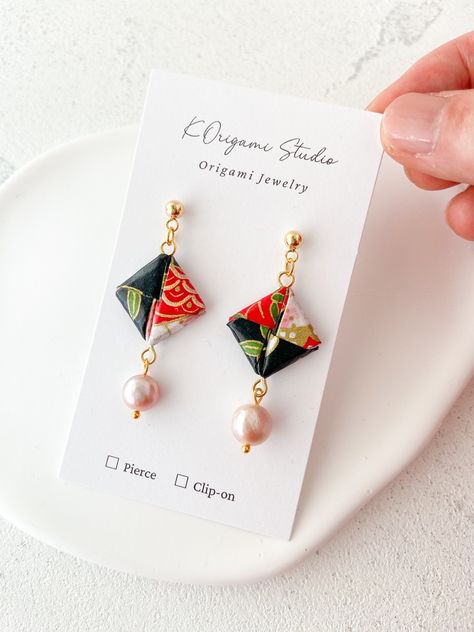 Dangling square origami earrings with high quality Yuzen washi paper and pearls They are very light weight, you can wear them all day with no stress. If you want to add something unique different from others, they are perfect for you! You will get a lot of compliments on them. I carefully fold them to show beautiful part of the paper. They are absolutely one of a kind! I finished them with a varnish, not with a resin, because I want to preserve paper texture, and you to enjoy all texture, colors and designs.  Materials: Yuzen washi paper water pearl 18K gold plated earring stud Care: Finished with several layers of a varnish, allowing the jewelry to be water resistant. Store your earrings in a cool, dry place. Avoid direct contact with perfume, body lotions or other liquids. Wipe the metal Square Origami, Japanese Earrings, Origami Earrings, Geometric Origami, Pearl Light, Japanese Jewelry, Origami Jewelry, Jewelry Care Instructions, Washi Paper