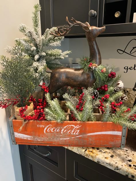 A vintage Coca-Cola crate is the ideal base for this reindeer display, and it’s a perfect holiday centerpiece!! Coke Crate Christmas Decor, Christmas Crates, Reindeer Christmas Decorations, Wooden Crate Ideas, Diy Christmas Flower Arrangements, Old Coke Crates, Wooden Crates Christmas, Primitive Christmas Ornaments, Holiday Floral Arrangements