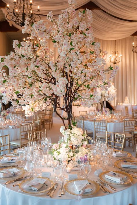 wedding centerpiece tall cherry blossom faux tree with white pink flowers at base round table wedding Cherry Blossom Wedding Centerpieces, Cherry Blossom Centerpiece, Blossom Tree Wedding, Tree Wedding Centerpieces, Cherry Blossom Wedding Theme, Round Wedding Tables, Cherry Blossom Theme, Garden Backdrops, Inside Weddings