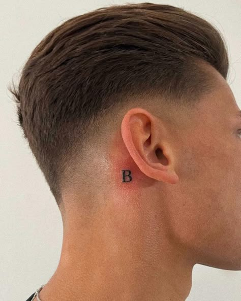 Letter tattoo behind ear / font Initials Tattoo Behind Ear, Small Initial Tattoo Behind Ear, Letter Tattoos Initials Behind Ear, R Tattoo Behind Ear, Letter Ear Tattoo, Neck Initial Tattoo, Capital B Tattoo, Small Letter Tattoo Behind Ear, Behind The Ear Letter Tattoo