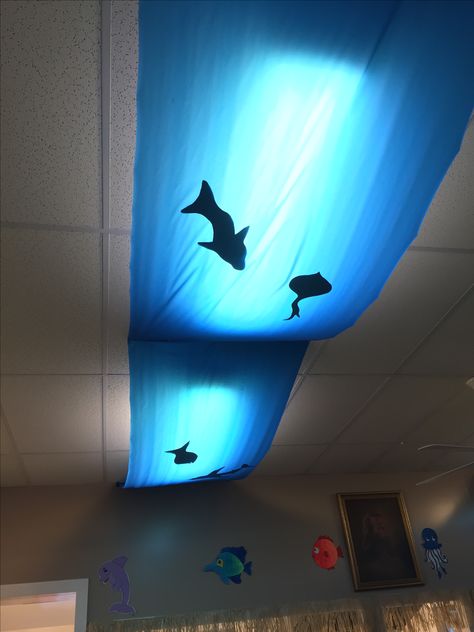 Surf Shack VBS undersea lights. Vbs Boat Decorations, Jonah And The Whale Decorations For Vbs, Beach Stage Decor, Life Way Vbs 2024, Scuba Vbs Imagination Station, Gone Fishing Vbs Ideas, Luau Vbs Decorations, Scuba Vbs Registration Table, Nautical Vbs Decorations