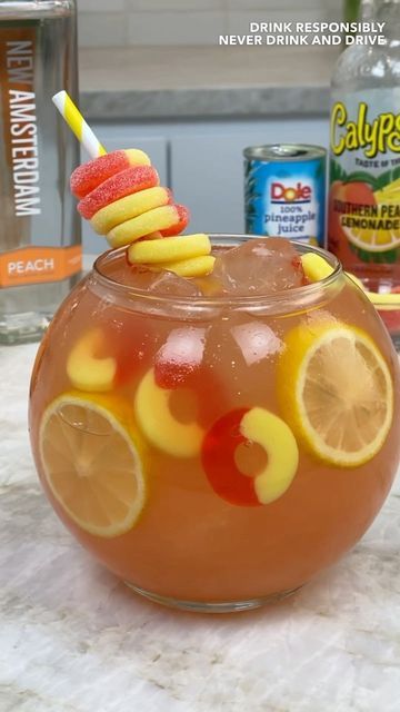 TIPSY BARTENDER 🍻🍹 on Instagram: "Crown Peach Fishbowl 🍑" Fishbowl Drink Mocktail, Diy Fishbowl Drink, Applebees Shark Bowl Drink Copycat, Kids Fishbowl Drink, Fish Bowl Drink Recipe, Fishbowl Recipes, Fish Bowl Drink, Fishbowl Cocktail, Tipsy Bartender Recipes