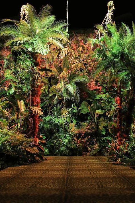 Floral foliage and tropical prints were at the fore of Dolce & Gabbana’s jungle-inspired SS20 collection in Milan, where the interiors of their Metropol show space morphed into a slice of the Amazon.  Floral set designers Rattiflora flanked the runway with hundreds of plants, as models emerged between palm tree leaves dressed in safari-inspired khaki jumpsuits and floral printed dresses.  Photo via Dolce & Gabbana   #fashionweek #installation #event Plant Installation, Neon Jungle, Floral Foliage, Fiesta Tropical, Jungle Room, Havana Nights, Palm Tree Leaves, Tropical Prints, Jungle Party