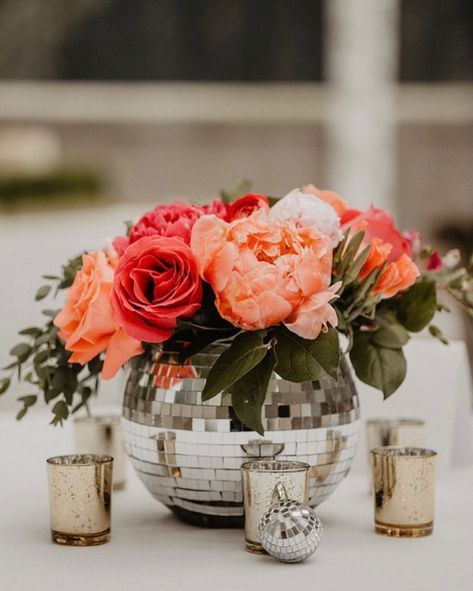 Disco ball vase at a June wedding with bright boho vibes Disco Ball Flower Vase, Coral Theme Birthday Party, Groovy Theme Centerpieces, Engagement Party Disco Theme, Disco Ball Planter Centerpiece, Flower Arrangements With Disco Balls, Mirrorball Centerpiece, Disco Ball Floral Centerpiece, Wedding Centerpieces Disco Ball