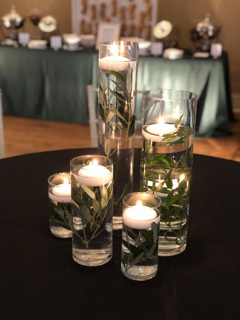 Safe Green Centerpieces, Emerald Flower Arrangement, Greenery And Candles Centerpieces, Olive Centerpiece Table Decorations, Emerald And Black Centerpieces, Deep Green Wedding Table Decor, Forest Green Centerpieces Wedding, Black Green Gold Wedding Receptions, Emerald Green Black And Gold Wedding Centerpiece