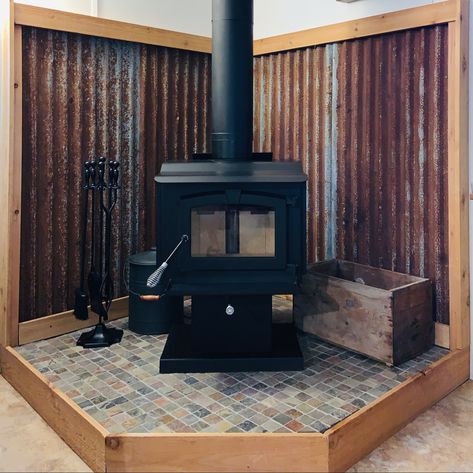 Wood Stove Tin Surround, Mobile Home Wood Stove, Wood Stove In Cabin, Corrugated Metal Wood Stove Surround, Corrugated Metal Wall Wood Stove, Fireproof Wall Behind Wood Stove, Tin Behind Wood Stove, Wall Behind Wood Stove Ideas, Wood Stove In Mobile Home