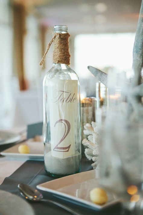 Daytona Beach Shores Wedding from Monika Gauthier Photography Read more - http://www.stylemepretty.com/florida-weddings/2013/09/04/daytona-beach-shores-wedding-from-monika-gauthier-photography/ Beach Wedding Tables, Beach Wedding Centerpieces, Nautical Wedding Theme, Wedding Bottles, Beach Wedding Decorations, Beach Wedding Favors, Wedding Table Decorations, Classy Wedding, Beach Theme Wedding