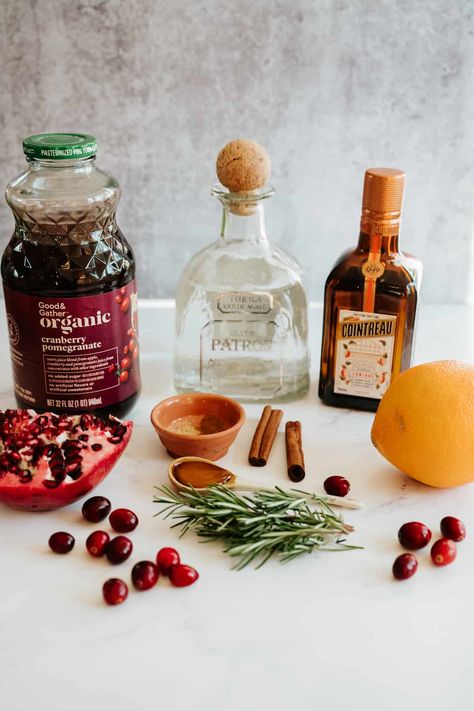 Delight in the holiday spirit with this Spiced Pomegranate Cranberry Margarita! A festive mix of pomegranate-cranberry juice, fresh orange juice, smooth tequila, orange liquor, & a hint of agave, spiced with cinnamon & ginger. Garnished with rosemary, cranberries, & pomegranate seeds, it's the perfect balance of sweet, tart, & cozy. Easy to make, stunningly seasonal, & can be adapted into a refreshing mocktail. A must-try cocktail for your holiday celebrations! #HolidayCocktail #MargaritaRecipe Pomegranate Ginger Cocktail, Cranberry Pomegranate Margarita, Pomegranate Rosemary Cocktail, Cranberry Jalapeno Margarita, Pomegranate Cranberry Cocktail, Tequila Cranberry Cocktail, Sparkling Drinks Cocktails, Christmas Garnish, Holiday Margaritas