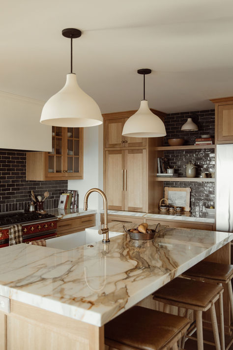 Nestled on the shores of Lake Superior in Duluth, Minnesota, a charming home recently underwent a remarkable transformation, with its kitchen taking center stage. Tap on the image and read the blog to learn more! Transitional Kitchen Tile Floor, Granite With Stained Cabinets, Milky Granite Countertops, Marble Countertops Kitchen Wood Cabinets, Light Countertops Wood Cabinets, Light Wood Cabinets Dark Countertops, Wood Cabinets Dark Countertops, Lights Over Island In Kitchen, Light Oak Cabinets Kitchen